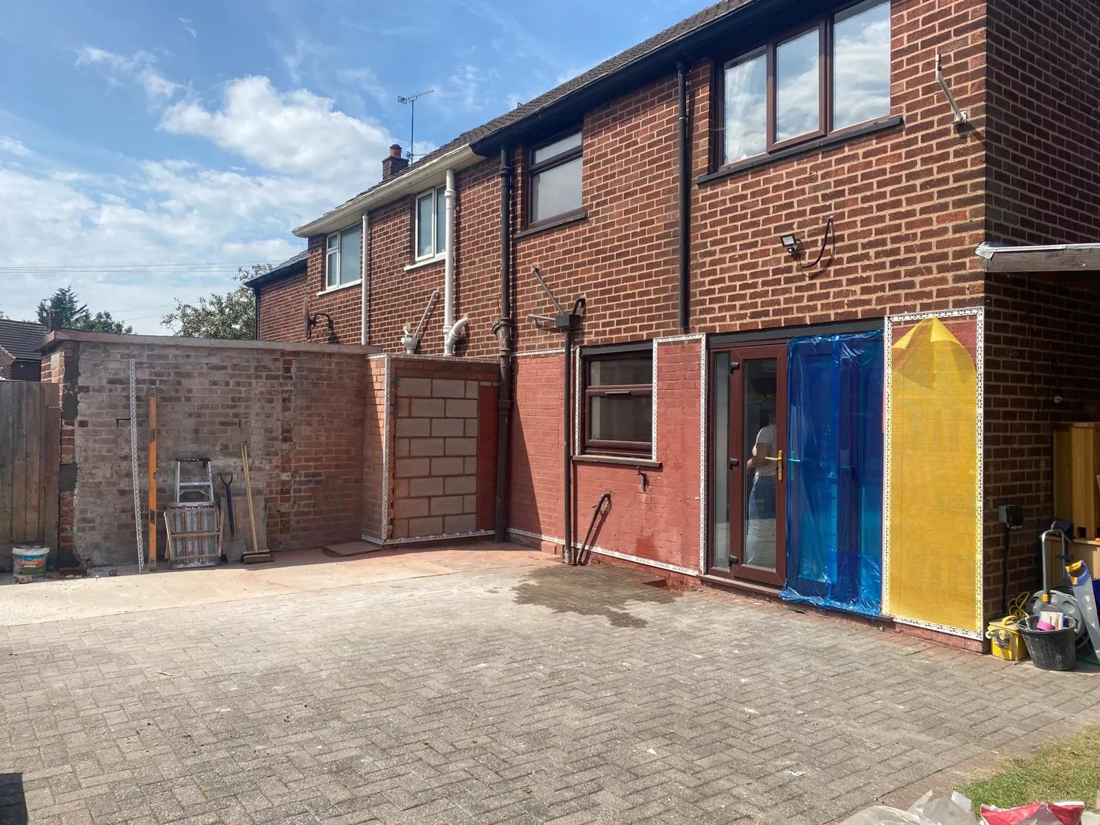 A brick house with a blue and yellow door.