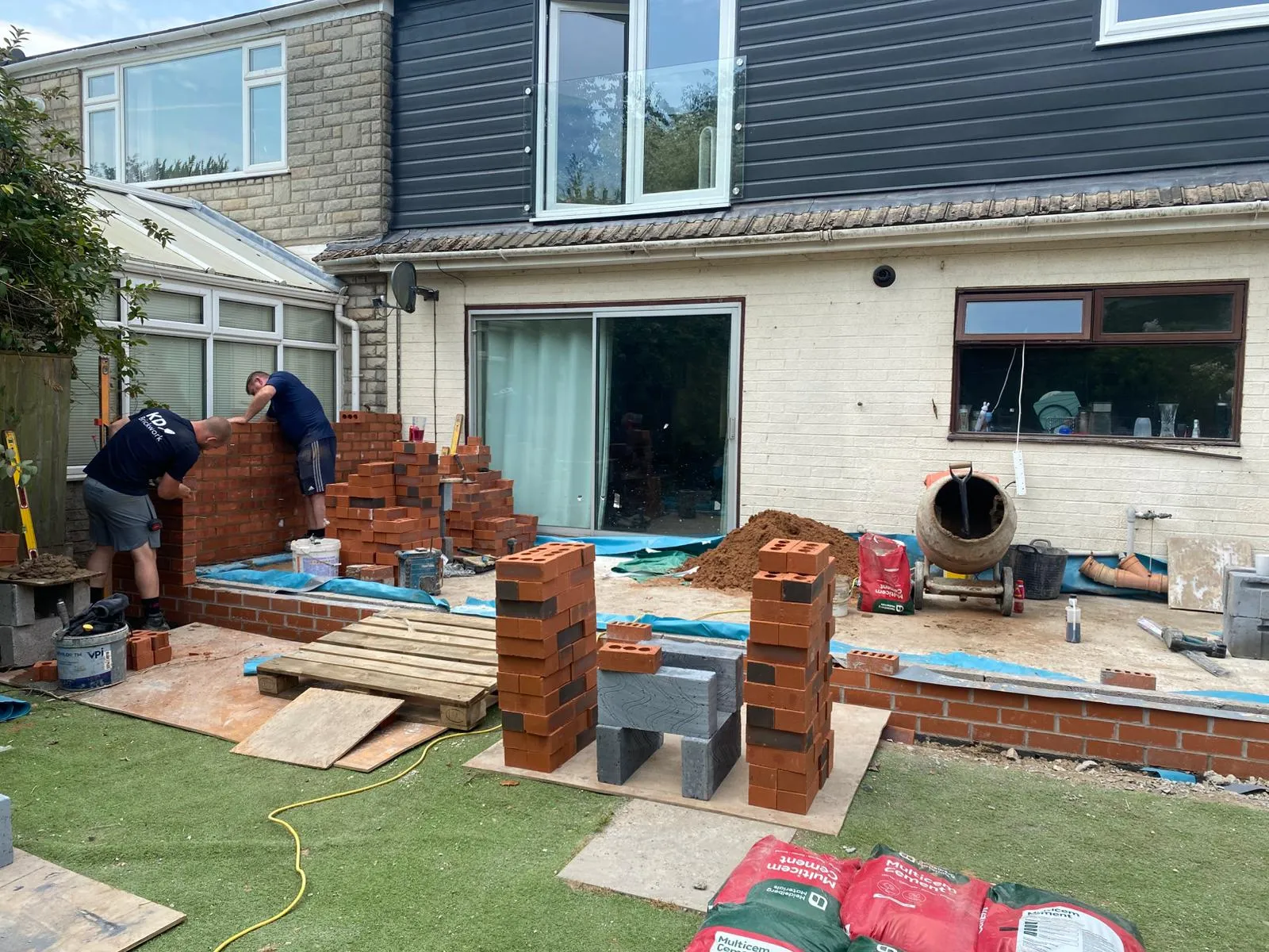 A couple of men are building a house.