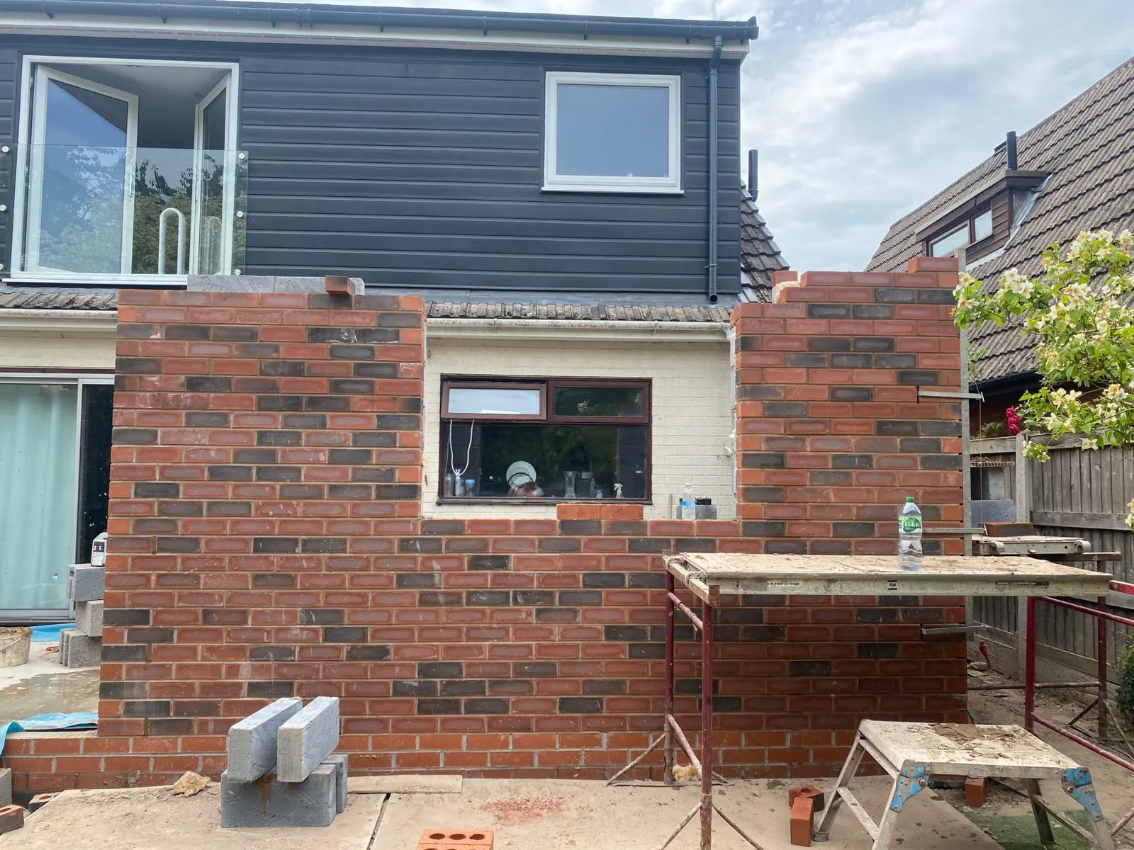 A house with a brick wall and a window.